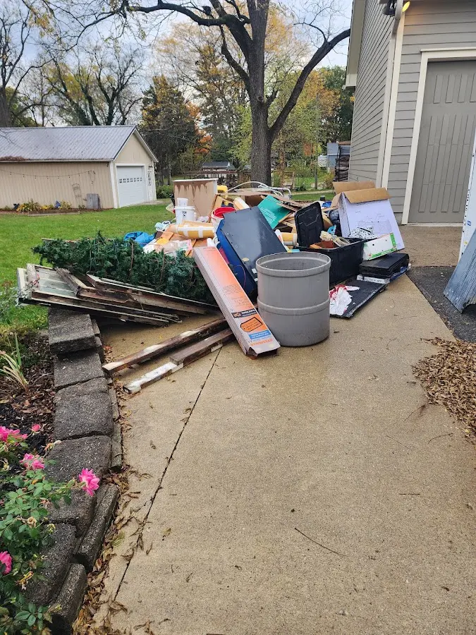 Dumpster being loaded with debris for Estate Cleanout Dumpster Rental in Daleville